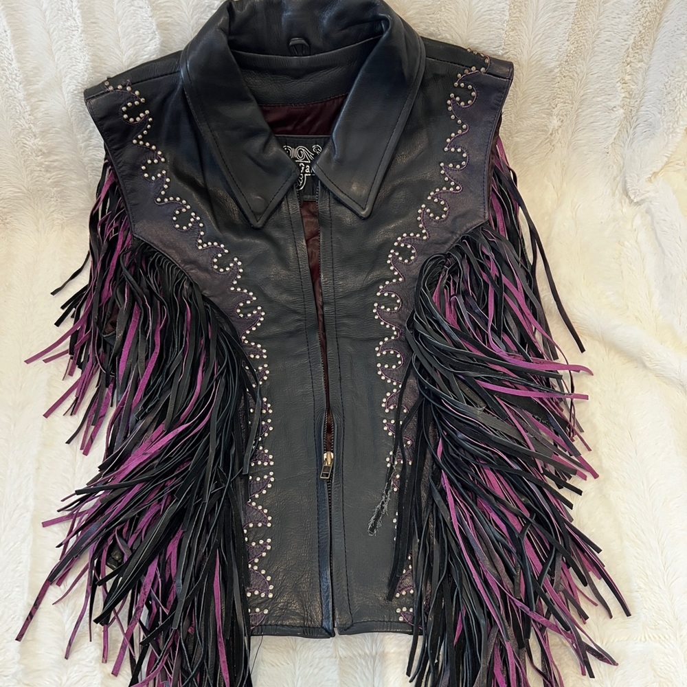 Leather black and purple vest. Fits like a medium although labeled a large.